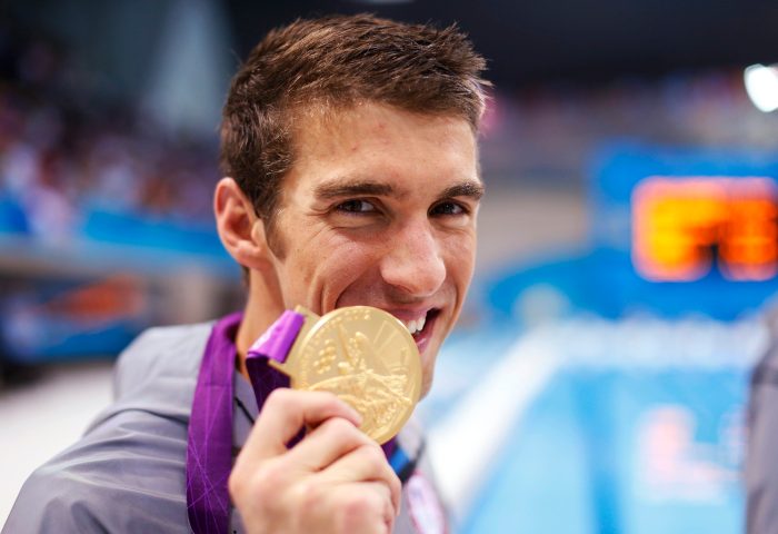 Michael Phelps of the U.S. poses with his gold medal after winning the men's 4x100m medley relay final during the London 2012 Olympic Games at the Aquatics Centre